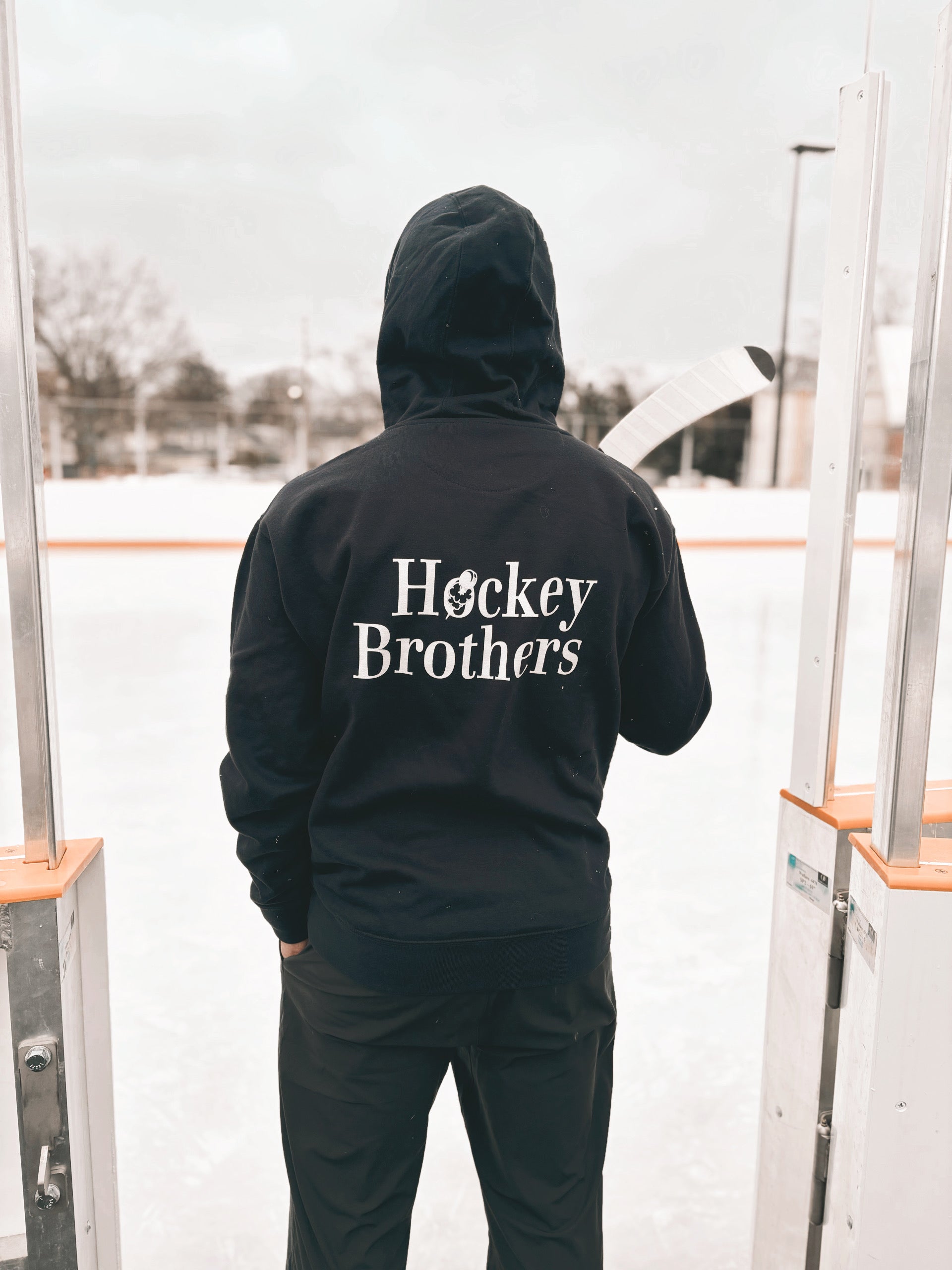 Hockey Brothers embroidered hoodie photoshoot. Im standing at the door of an outdoor rink about to go on the ice